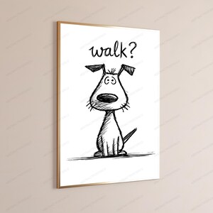May include: A framed wall art print featuring a black ink sketch of a dog on a white background. The dog has large eyes, a prominent nose, and floppy ears. Above the dog, the word walk? is written in a handwritten, cursive black font style.