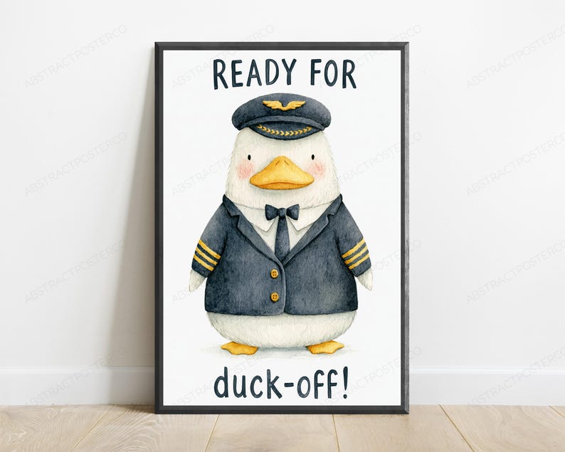 May include: A framed wall art print featuring a white duck dressed as a pilot in a dark blue uniform with gold stripes, a black tie, and a pilot cap. The text READY FOR is printed above the duck, and the text duck-off! is printed below the duck.