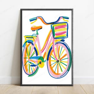 May include: A framed wall art print featuring a colorful, painterly illustration of a bicycle. The bicycle is rendered in vibrant strokes of pink, blue, yellow, orange, and green, complete with a front basket and a bright orange seat.
