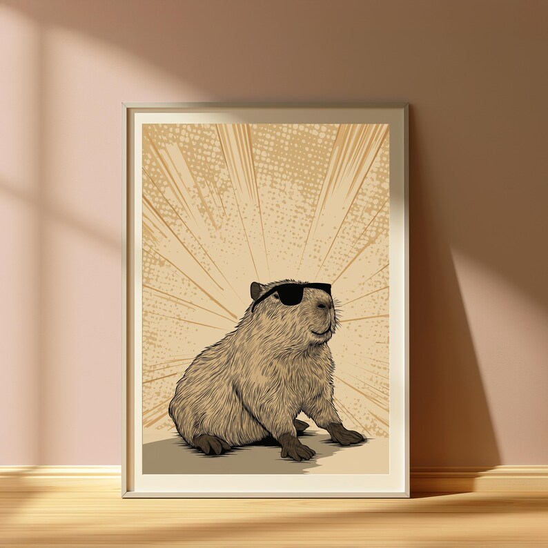 May include: A framed wall art print featuring a detailed illustration of a capybara wearing black sunglasses. The capybara is rendered in shades of brown and tan, set against a light beige background with radiating sunburst lines and a dotted texture.