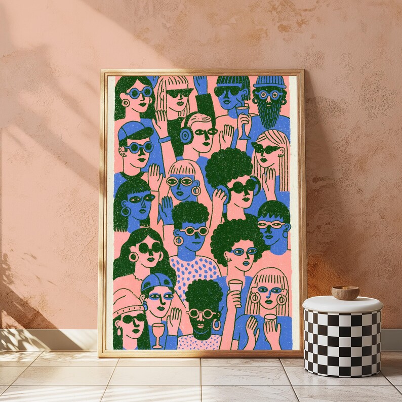 May include: A framed rectangular art print featuring a dense crowd of people illustrated in a flat graphic style. The figures are rendered in blue and green ink on a light pink background, many wearing sunglasses and holding small drinking glasses.