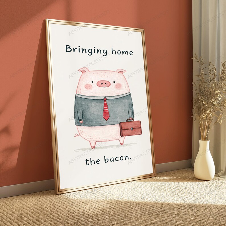 May include: A framed wall art print featuring a cartoon pig wearing a grey suit jacket and a red striped tie. The pig is holding a brown briefcase. The text "Bringing home" is printed above the pig, and "the bacon." is printed below it.