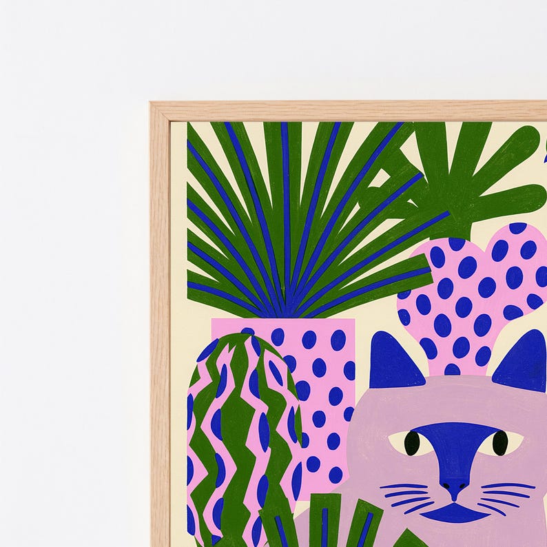 May include: A framed art print featuring a light purple cat with a dark blue face mask, surrounded by stylized potted plants. The plants include a green palm, a pink cactus with blue dots, and a green cactus with pink wavy vertical stripes.