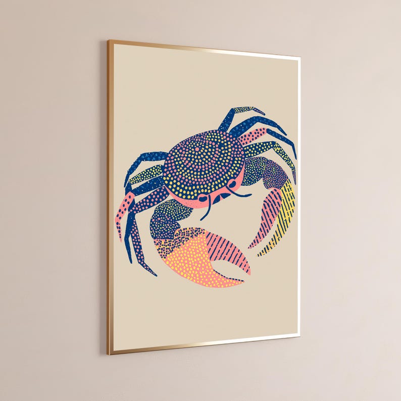 May include: A framed wall art print featuring a stylized crab illustration on a light beige background. The crab is rendered in navy blue, pink, and yellow, utilizing a mix of dotted, stippled, and striped patterns across its shell and legs.