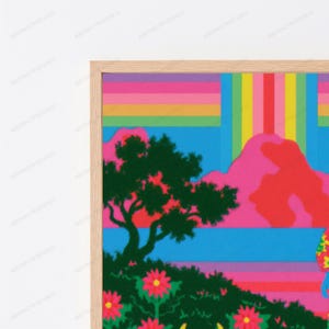以下が含まれることがあります： 濃い緑の木、ピンクの山々、青い空が描かれた鮮やかな風景の額入りウォールアートプリント。上部にはピンク、黄色、緑の水平ストライプがあり、前景には赤い花が描かれています。
