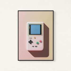 May include: A framed wall art print featuring a light-coloured handheld video game console with a blue screen, a black directional pad, and circular green and pink buttons, set against a soft gradient background transitioning from pink to yellow.