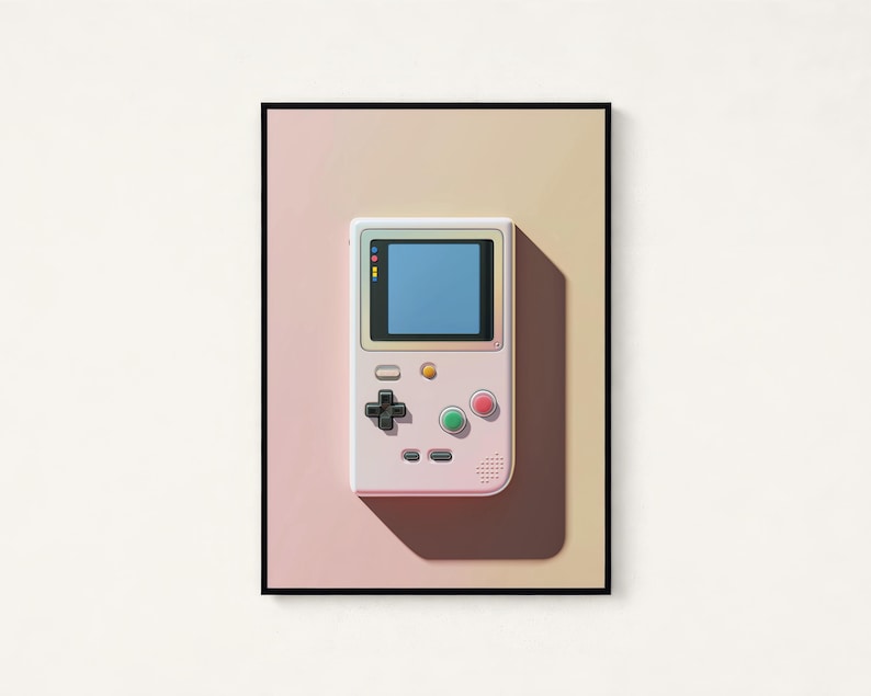 May include: A framed wall art print featuring a light-coloured handheld video game console with a blue screen, a black directional pad, and circular green and pink buttons, set against a soft gradient background transitioning from pink to yellow.