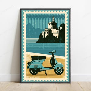 May include: A framed wall art print designed like a postage stamp featuring a light blue scooter parked on a tan surface. The background displays a coastal scene with a white building on a dark cliffside overlooking blue water and a bridge.
