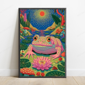May include: A framed wall art print featuring a vibrant, colorful illustration of a large, pink-spotted frog sitting in a pond. The scene includes a bright pink lotus flower, green lily pads, red mushrooms, and a glowing orange sun in a blue sky.