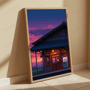 May include: A framed vertical art print featuring a pixel art style illustration of a train station building at sunset. The scene displays a dark wooden structure with a tiled roof, warm glowing lights, and a vending machine under a purple sky.