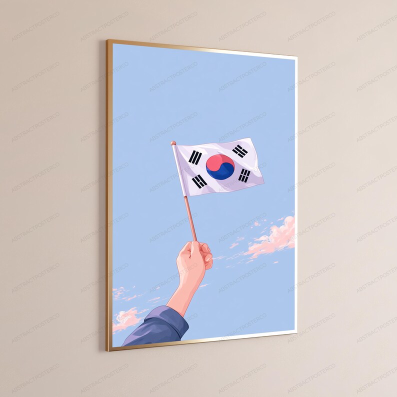 May include: A framed vertical wall art print featuring a hand holding a South Korean flag against a light blue sky with soft pink clouds. The flag displays the central red and blue taegeuk symbol surrounded by four black trigrams on a white field.