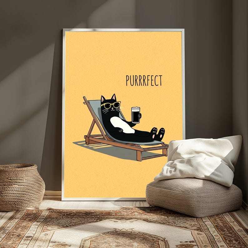 May include: A framed wall art print featuring a black cat with a white belly wearing yellow sunglasses, lounging on a wooden beach chair while holding a dark beverage. The background is a solid yellow color with the text PURRRFECT printed above.