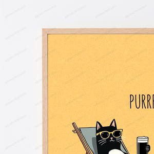 May include: A framed wall art print featuring a black cat wearing yellow sunglasses, lounging in a gray beach chair on a solid yellow background. The text PURR reads in black capital letters. The frame is made of light-colored natural wood.