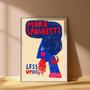 May include: A framed wall art print on a light beige background featuring a blue stylized figure with a large blue hairstyle. The text reads MORE SPAGHETTI at the top and LESS UPSETTI at the bottom in red. The figure has a red cheek, red earring, and red spaghetti.