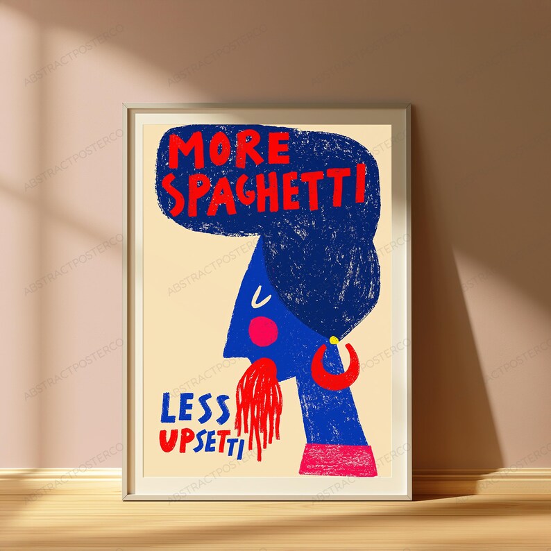 May include: A framed wall art print on a light beige background featuring a blue stylized figure with a large blue hairstyle. The text reads MORE SPAGHETTI at the top and LESS UPSETTI at the bottom in red. The figure has a red cheek, red earring, and red spaghetti.