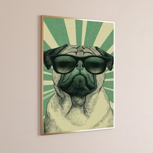 May include: A rectangular wall art print featuring a detailed illustration of a pug wearing black sunglasses. The dog is centered against a background of radiating green and cream-colored sunburst lines, creating a bold, graphic visual effect.