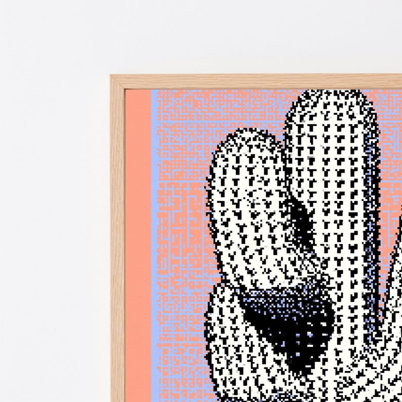 May include: A framed wall art print featuring a pixelated cactus illustration in black and white against a light blue and peach background with a maze-like pattern. The artwork is encased in a light-toned wooden frame with a clean, simple border.