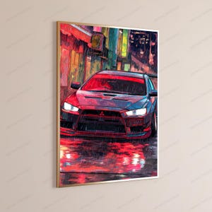 May include: A framed vertical wall art print depicting a red sports car parked on a wet city street at night. The scene features heavy rain, vibrant red reflections on the ground, and a dark urban background with glowing lights in a painterly style.
