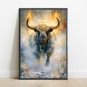 May include: A framed wall art print featuring an oil painting of a powerful bull with large curved horns. The bull is depicted in a dynamic, forward-facing pose, surrounded by a swirling, ethereal mist of golden, blue, and white brushstrokes.
