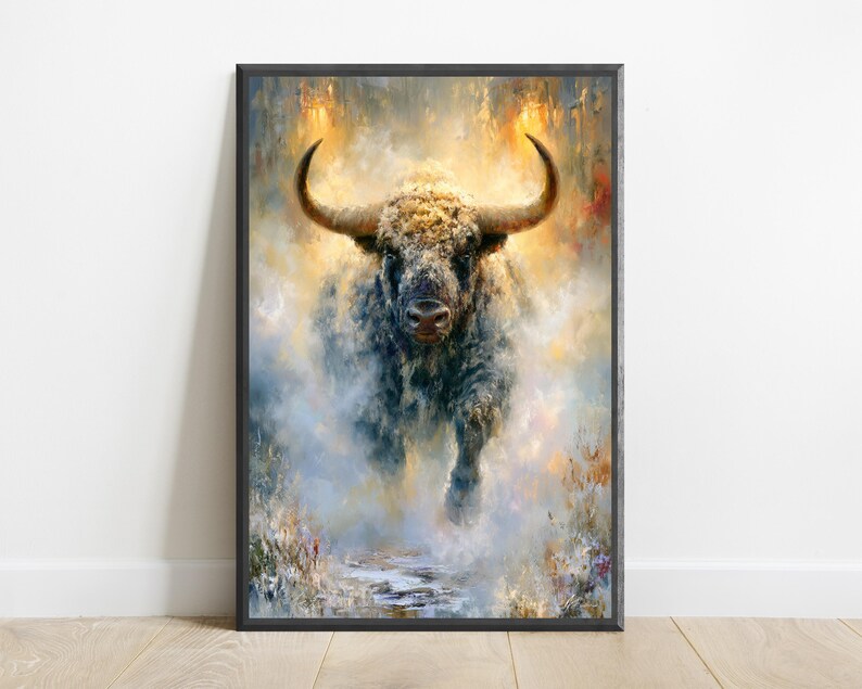 May include: A framed wall art print featuring an oil painting of a powerful bull with large curved horns. The bull is depicted in a dynamic, forward-facing pose, surrounded by a swirling, ethereal mist of golden, blue, and white brushstrokes.