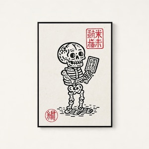May include: A rectangular art print featuring a black line drawing of a skeleton holding a small rectangular object. The print includes red Japanese characters in a square stamp at the top right and a circular red stamp at the bottom left.