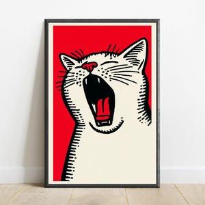 May include: A framed wall art print featuring a graphic illustration of a yawning white cat with black line details and a bright red background. The cat has its mouth wide open, showing a red tongue and dark interior, set against a solid red field.