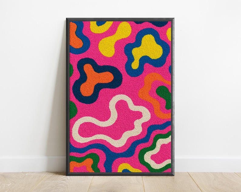 May include: A rectangular wall art piece featuring a vibrant, textured punch needle design. The surface displays an abstract pattern of irregular, amoeba-like shapes in bright yellow, orange, green, cream, and dark blue against a hot pink background.
