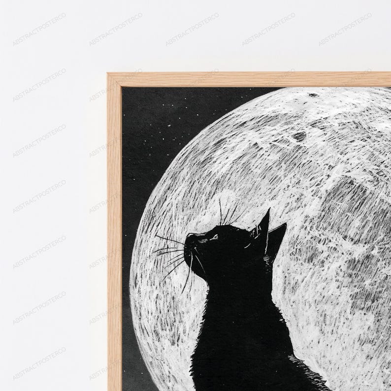 May include: A framed wall art print featuring a solid black cat silhouette in profile, looking upward toward a large, textured white full moon against a dark, starry night sky. The artwork is encased in a light-toned wooden frame.