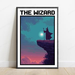 May include: A framed poster titled THE WIZARD featuring pixel art of a cloaked figure with a staff standing on a cliff edge. The scene depicts a dark purple and blue sky with a bright moon, transitioning to a pink and orange sunset at the horizon.