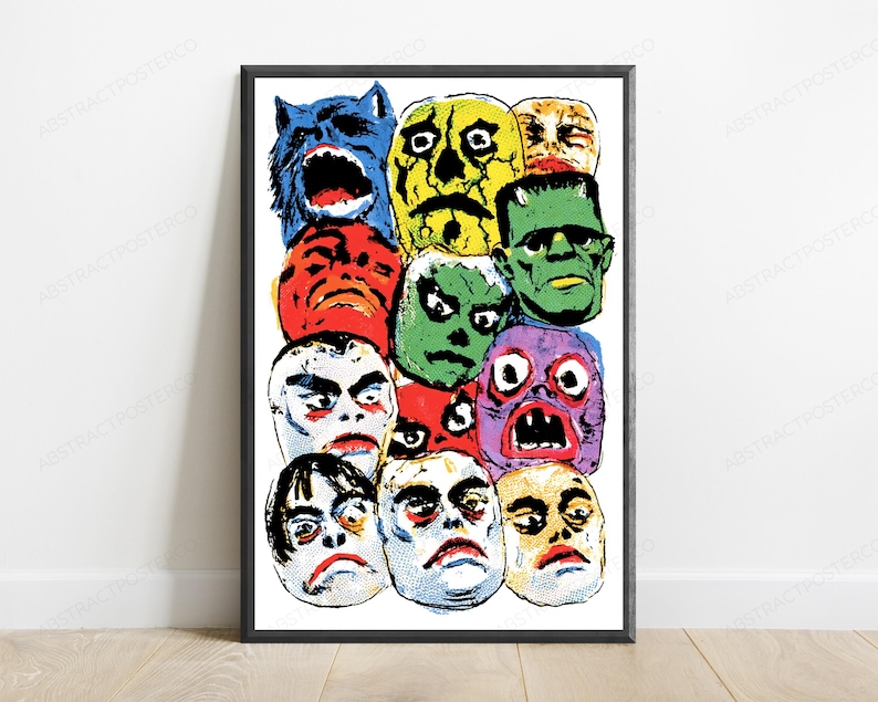 May include: A framed poster featuring a collage of colorful, stylized monster and creature faces in a comic book art style. The illustration includes a blue wolf, a yellow skull, a green Frankenstein-like figure, and various other expressive faces.