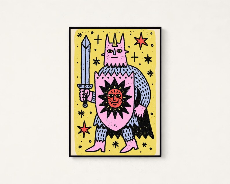 May include: A rectangular art print featuring a stylised pink creature with a horn, wearing blue chainmail armour and a black cape. The figure holds a grey sword and a pink shield with a black sun design against a yellow background with stars.