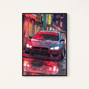 May include: A framed digital art print depicting a dark grey Mitsubishi Lancer Evolution saloon parked on a wet city street at night. The scene features vibrant red and orange light reflections on the rain-slicked ground and building walls.