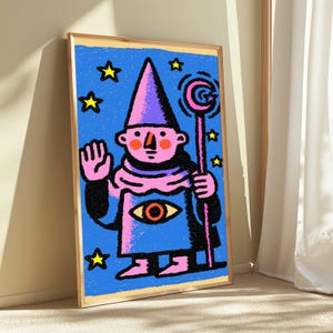 May include: A framed art print featuring a stylized illustration of a pink-skinned figure in a purple pointed hat and robe. The figure holds a staff with a crescent moon topper, has an eye symbol on the chest, and is surrounded by yellow stars.