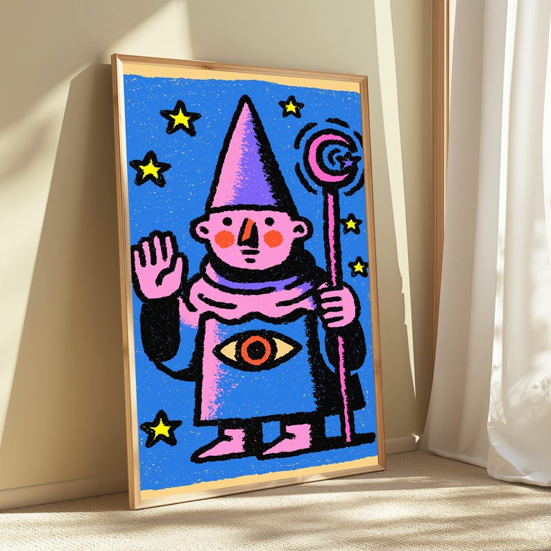 May include: A framed art print featuring a stylized illustration of a pink-skinned figure in a purple pointed hat and robe. The figure holds a staff with a crescent moon topper, has an eye symbol on the chest, and is surrounded by yellow stars.