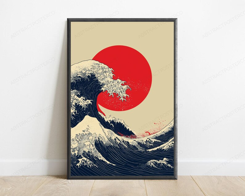 May include: A rectangular wall art print in a black frame featuring a stylized illustration of a large, dark blue ocean wave with white foam crests. A solid, vibrant red circle is positioned in the upper center against a light beige background.