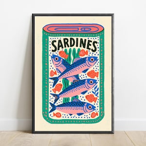 May include: A rectangular wall art print featuring a stylized illustration of an open tin of sardines. The design includes three large blue and pink fish, several smaller orange fish, and green seaweed accents on a cream background with the text SARDINES.