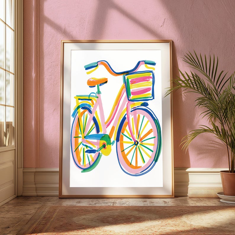 May include: A framed art print featuring a colorful, expressive illustration of a bicycle. The bicycle is rendered with bold, loose brushstrokes in shades of pink, orange, yellow, blue, and green, complete with a front basket and a rear rack.