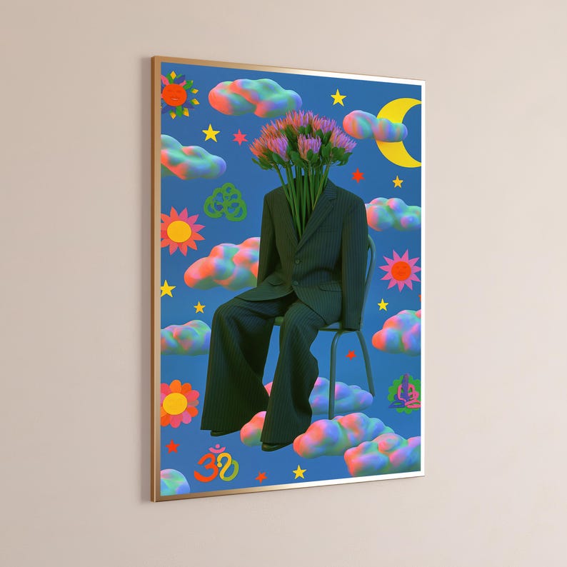 May include: A framed wall art print featuring a dark pinstriped suit sitting on a chair with a bouquet of pink flowers replacing the head. The blue background is filled with colorful clouds, yellow stars, suns, a crescent moon, and symbols.