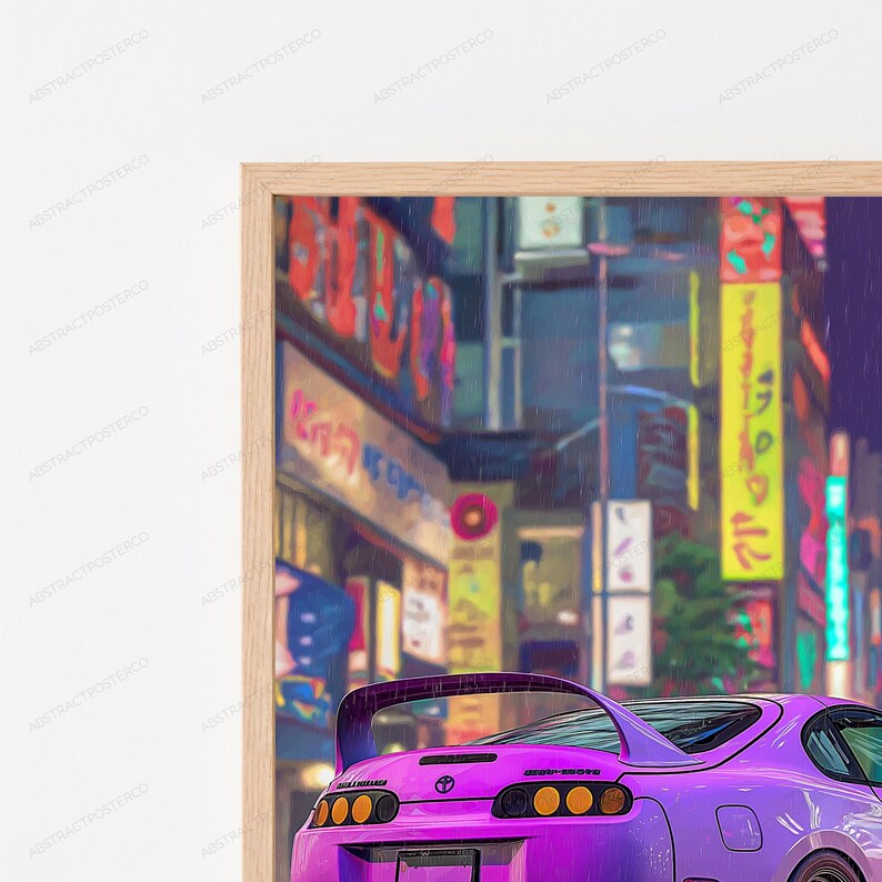 May include: A framed wall art print featuring a purple sports car viewed from the rear, positioned in front of a blurred city street scene at night with vibrant neon signs in yellow, pink, and blue, all encased in a light-colored wooden frame.
