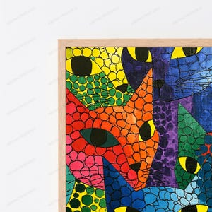 Puede incluir: Una impresi&oacute;n de arte mural enmarcada que presenta una ilustraci&oacute;n vibrante y multicolor de varias caras de gatos en estilo mosaico. Los gatos est&aacute;n representados en tonos brillantes de amarillo, naranja, rojo, rosa, azul, morado y verde.