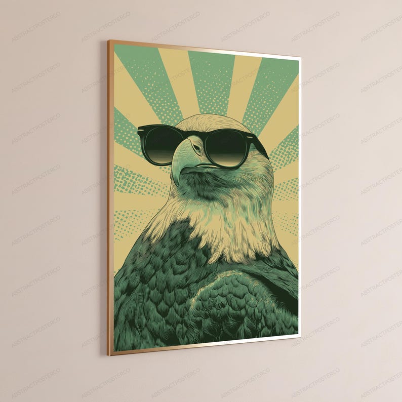May include: A rectangular wall art print featuring a stylized illustration of a bald eagle wearing black sunglasses. The eagle is set against a background of radiating light yellow and green sunburst rays with a subtle dotted texture pattern.