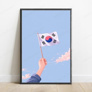 May include: A framed digital illustration featuring a hand holding a small South Korean flag against a light blue sky with soft pink clouds. The flag displays the white background, central red and blue taegeuk, and four black trigrams in corners.