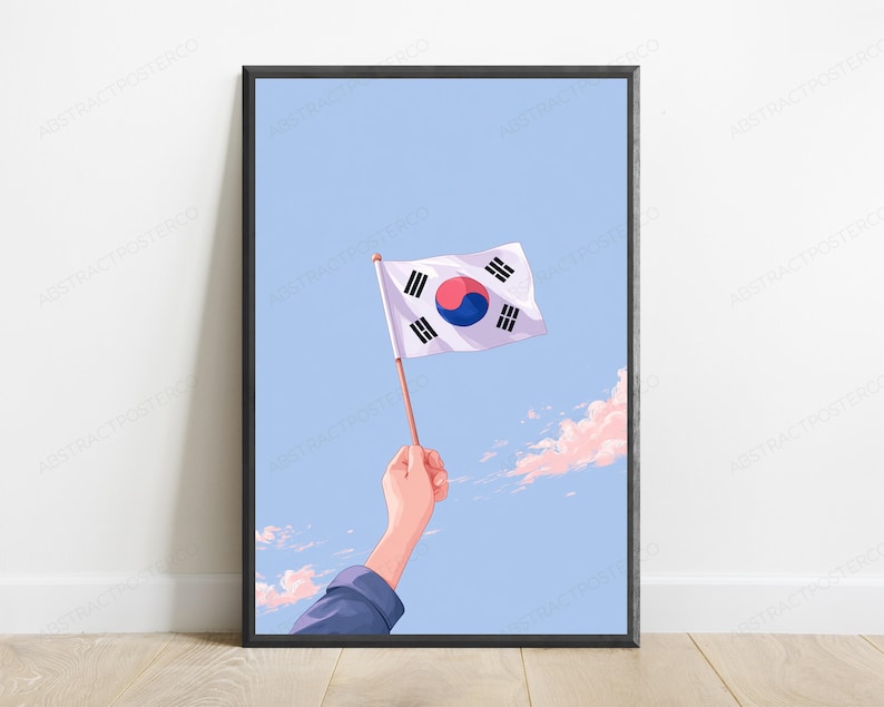 May include: A framed digital illustration featuring a hand holding a small South Korean flag against a light blue sky with soft pink clouds. The flag displays the white background, central red and blue taegeuk, and four black trigrams in corners.