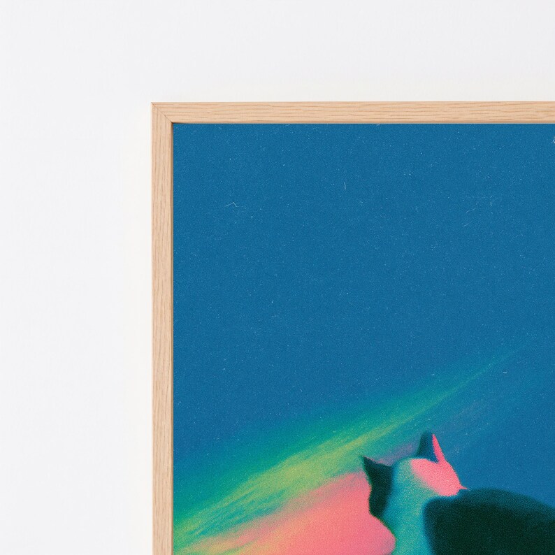 May include: A framed wall art print featuring a dark blue sky with a vibrant, glowing streak of green and pink light. The silhouette of a cat is visible in the lower right corner, looking toward the colorful light against the deep blue background.