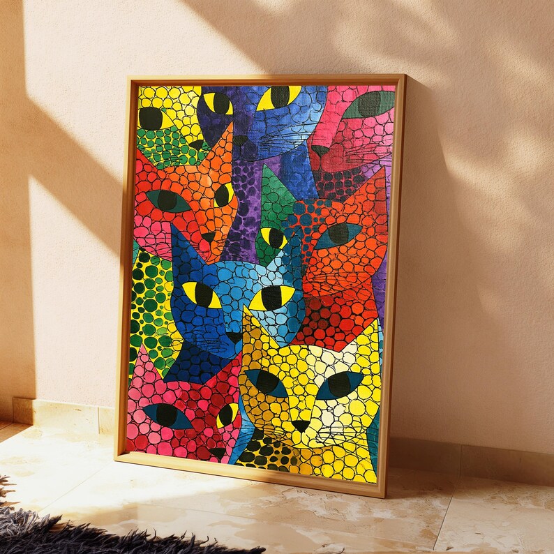 May include: A rectangular framed wall art print featuring a vibrant, multi-colored mosaic pattern of overlapping cat faces. The cats are rendered in bright shades of yellow, orange, red, blue, green, and pink, each covered in black circular spots.