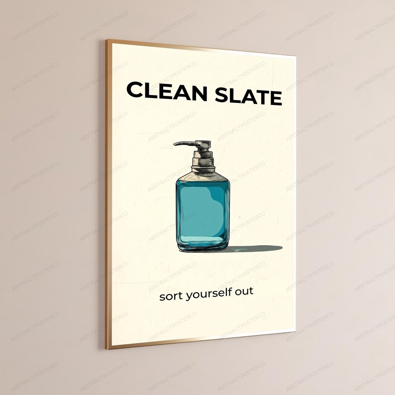 May include: A rectangular wall art print featuring a cream-colored background with the black text CLEAN SLATE at the top and sort yourself out at the bottom. Centered is a hand-drawn illustration of a blue liquid soap dispenser with a pump.