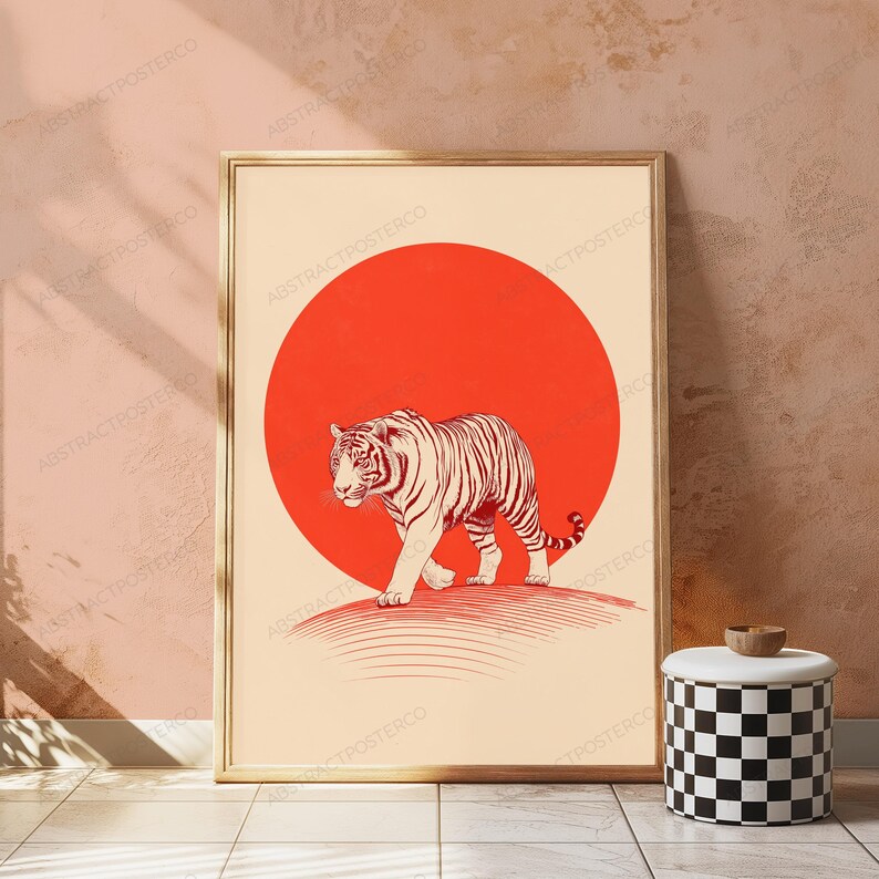 May include: A rectangular framed wall art print featuring a cream-coloured background with a large, solid red circle centred behind a detailed, line-art illustration of a tiger walking forward. The tiger is rendered in dark red ink lines.