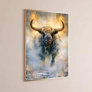 May include: A rectangular wall art print featuring an oil painting of a charging bull with large curved horns. The bull is rendered in shades of dark gray, brown, and cream, set against a hazy, ethereal background of golden yellow and white light.