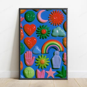 May include: A framed poster featuring a vibrant blue background covered in various glossy, three-dimensional-style icons including red hearts with faces, green suns, a rainbow, a pink hand, a yellow star, and green moon faces in a repeating pattern.