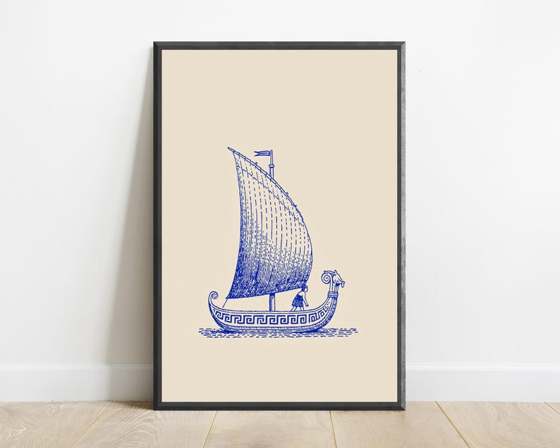 May include: A framed wall art print featuring a blue ink illustration of an ancient Greek ship with a large sail and a meander pattern along the hull. The ship is depicted on a light beige background, showcasing a figure on deck and a ram head prow.